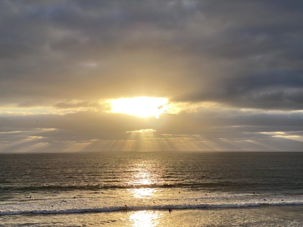 A pyramid of sunlight illuminates the evening sky in this breathtaking photo of a Pacific Beach sunset